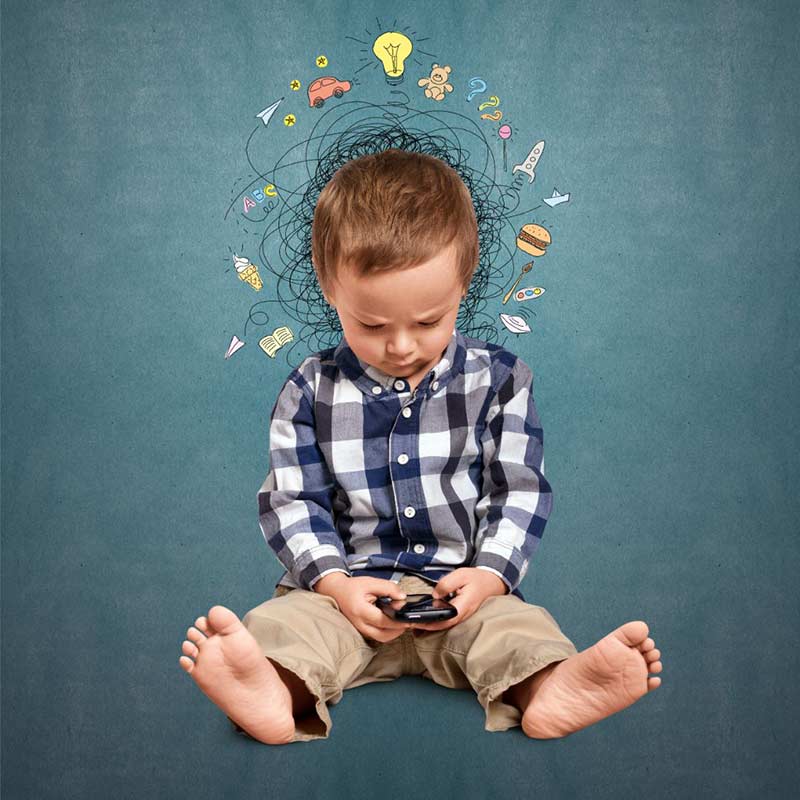 A little boy with a phone and confused icons above his head